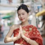 Portrait of a woman in traditional Thai attire posing outdoors in Bangkok.